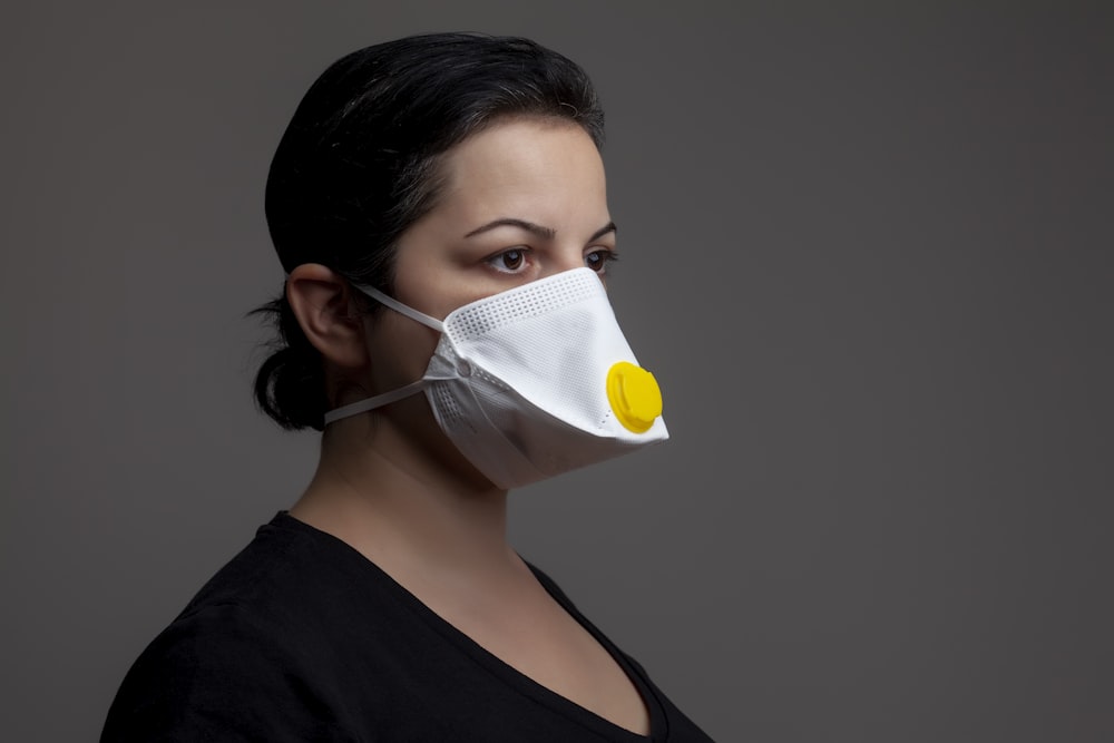 woman in black tank top with white face mask