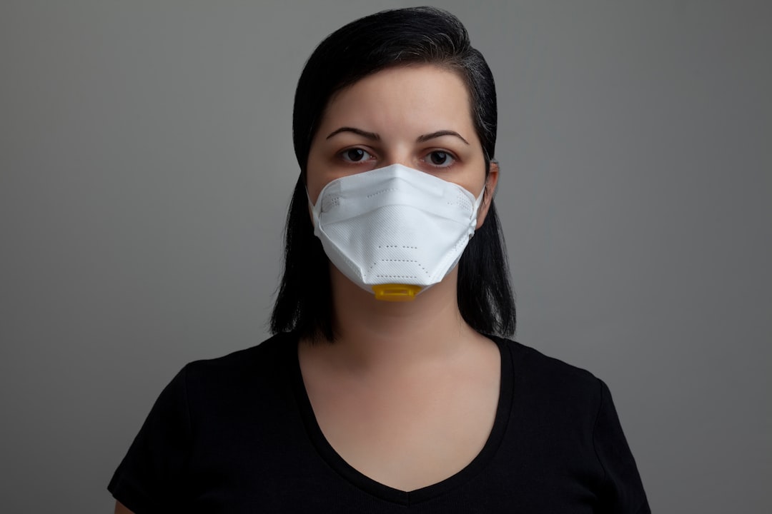 woman in black scoop neck shirt with white face mask