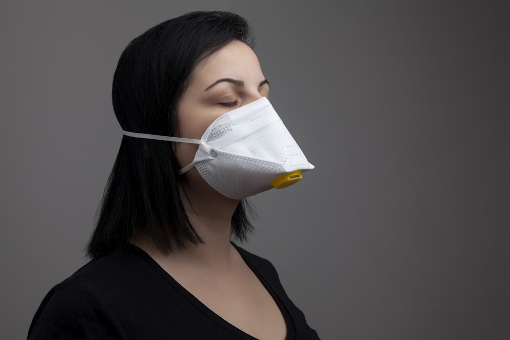 woman in black shirt with white mask