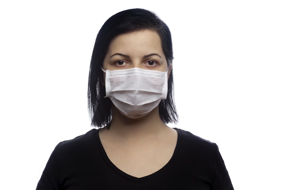 woman in black scoop neck shirt with white face mask