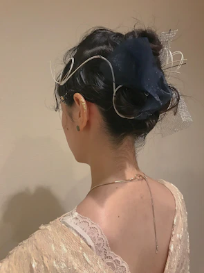 Elegant hairstyle featuring delicate curls and golden hair accessories.