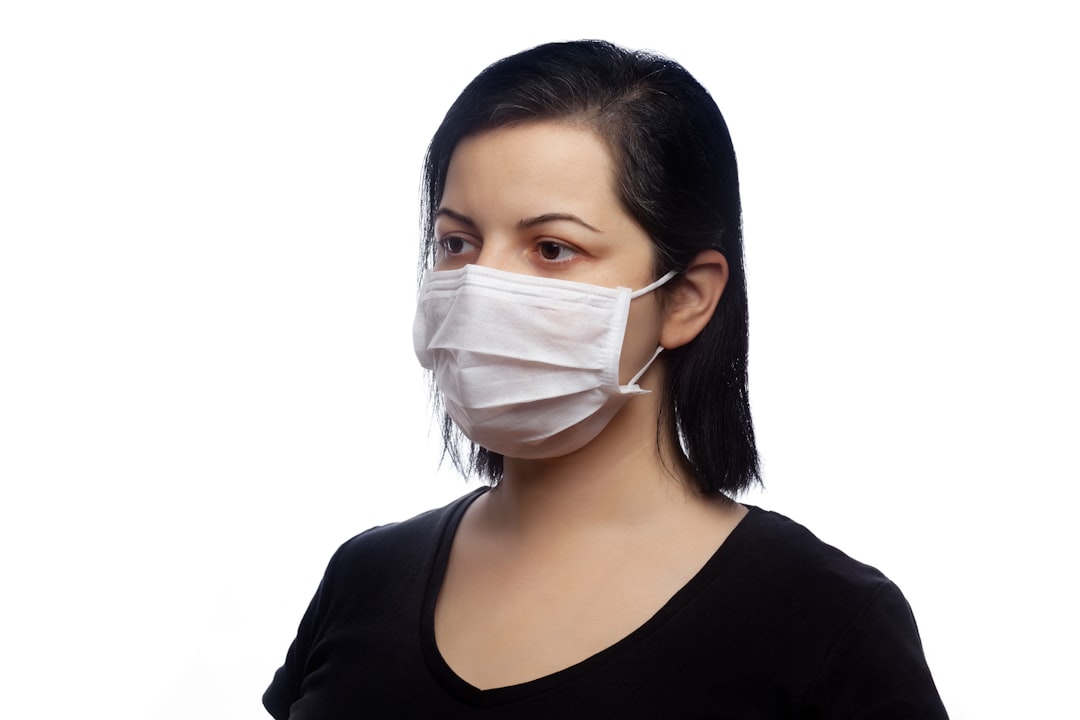 woman in black tank top with white face mask