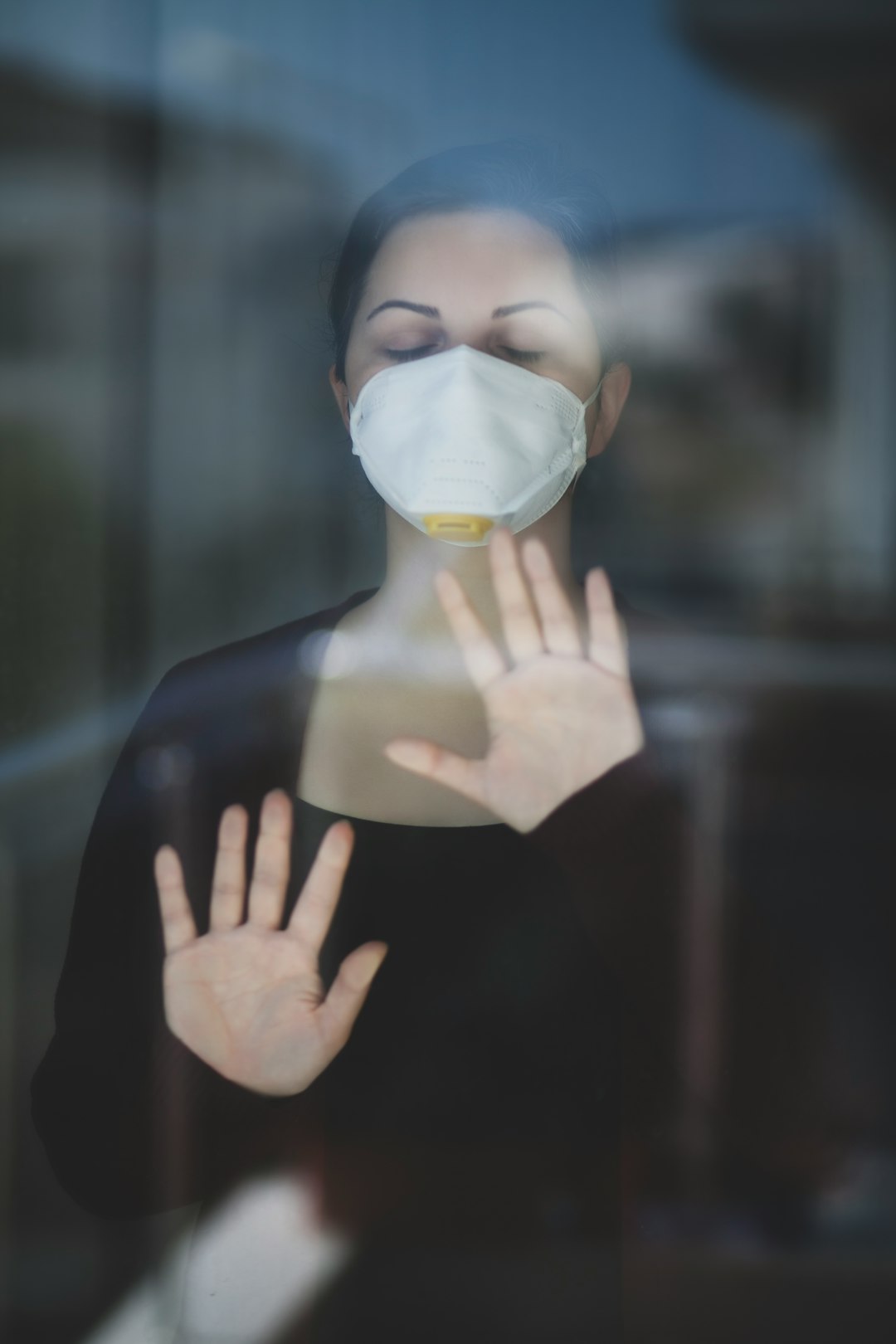 woman in black long sleeve shirt with white face mask