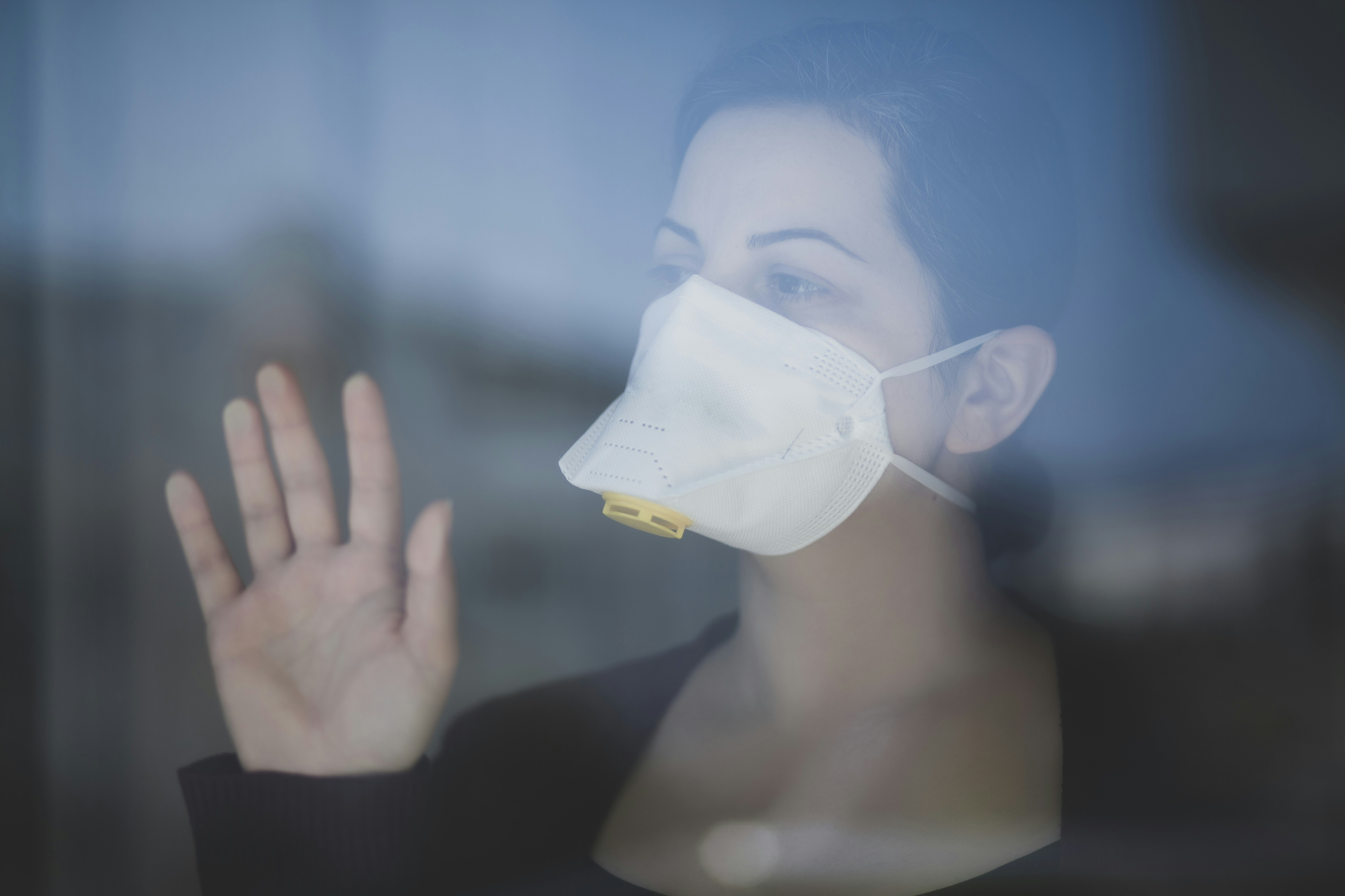 woman in black shirt holding white mask