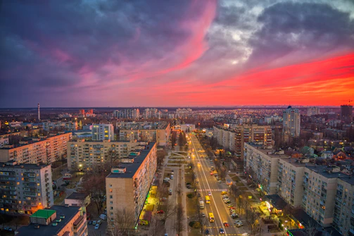 A vibrant cityscape blending purple and orange hues at dusk, symbolizing new beginnings.