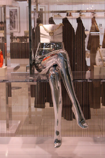 Close-up of a metallic-finished bra with sculpted silhouette on a mannequin.