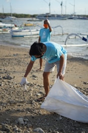 man in blue t-shirt and woman in white t-shirt on beach during daytime