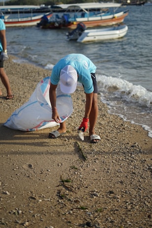 A diver carefully picking up trash from the ocean floor to protect marine life.