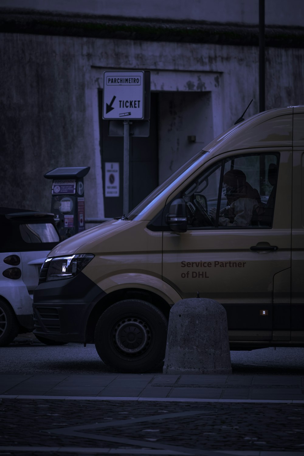 white van parked near building