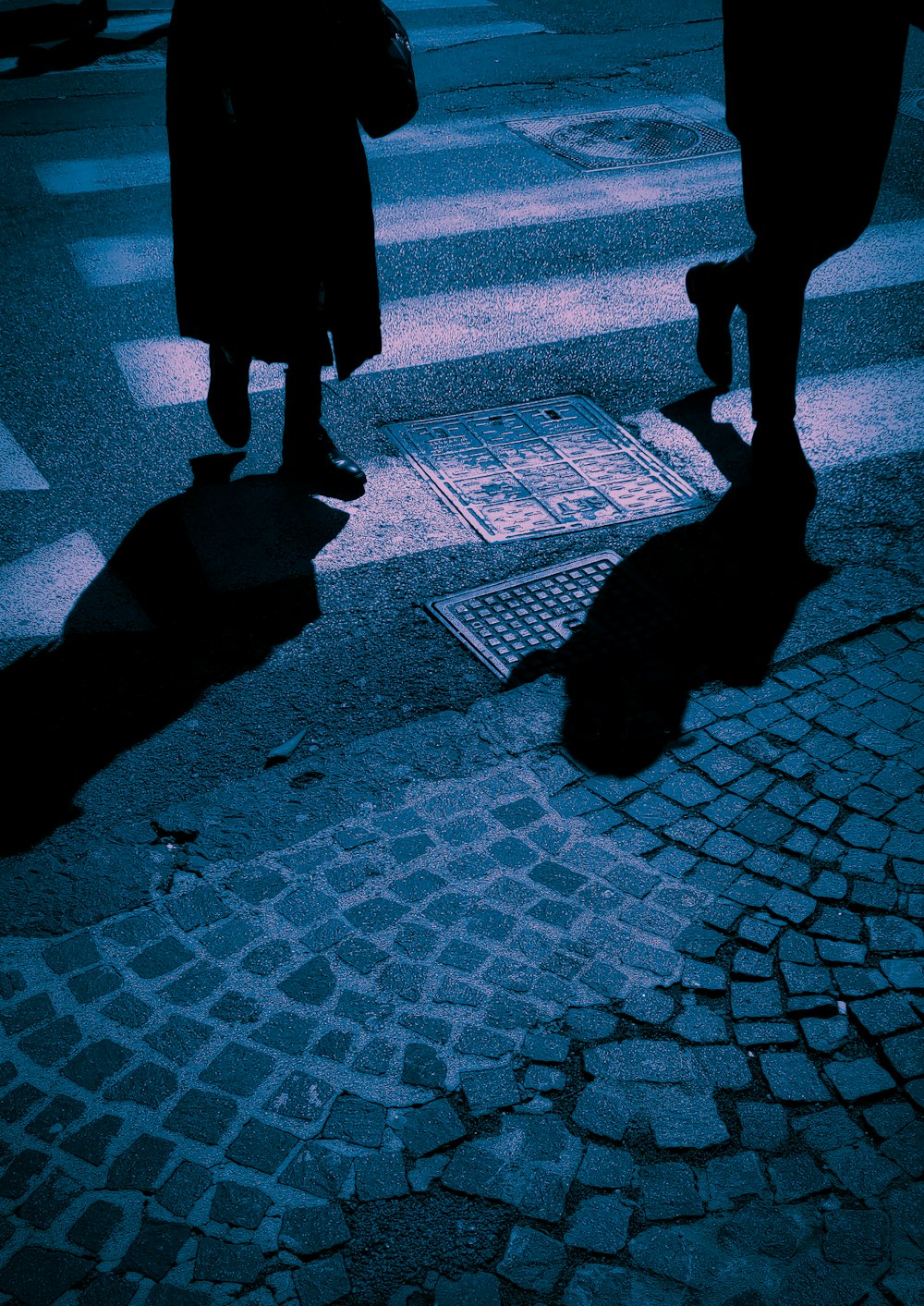 silhouette of person walking on street during daytime