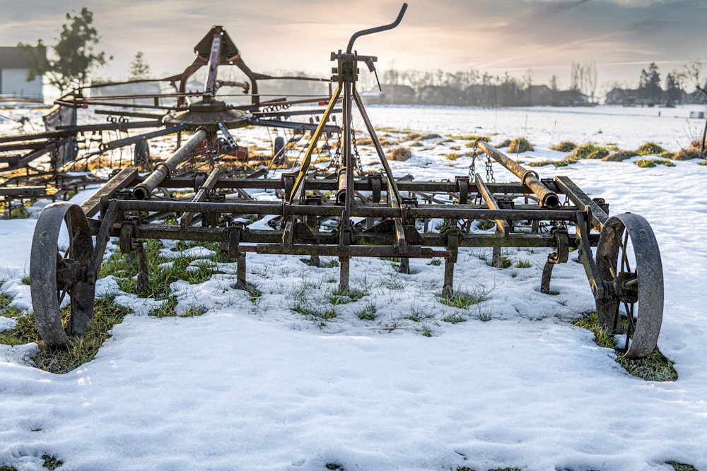 brown wooden picnic tables on snow covered ground during daytime