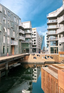 people walking on bridge near buildings during daytime
