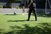 man in blue and white soccer jersey playing soccer
