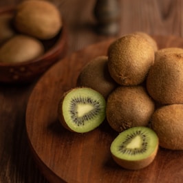 brown round fruit on brown wooden table