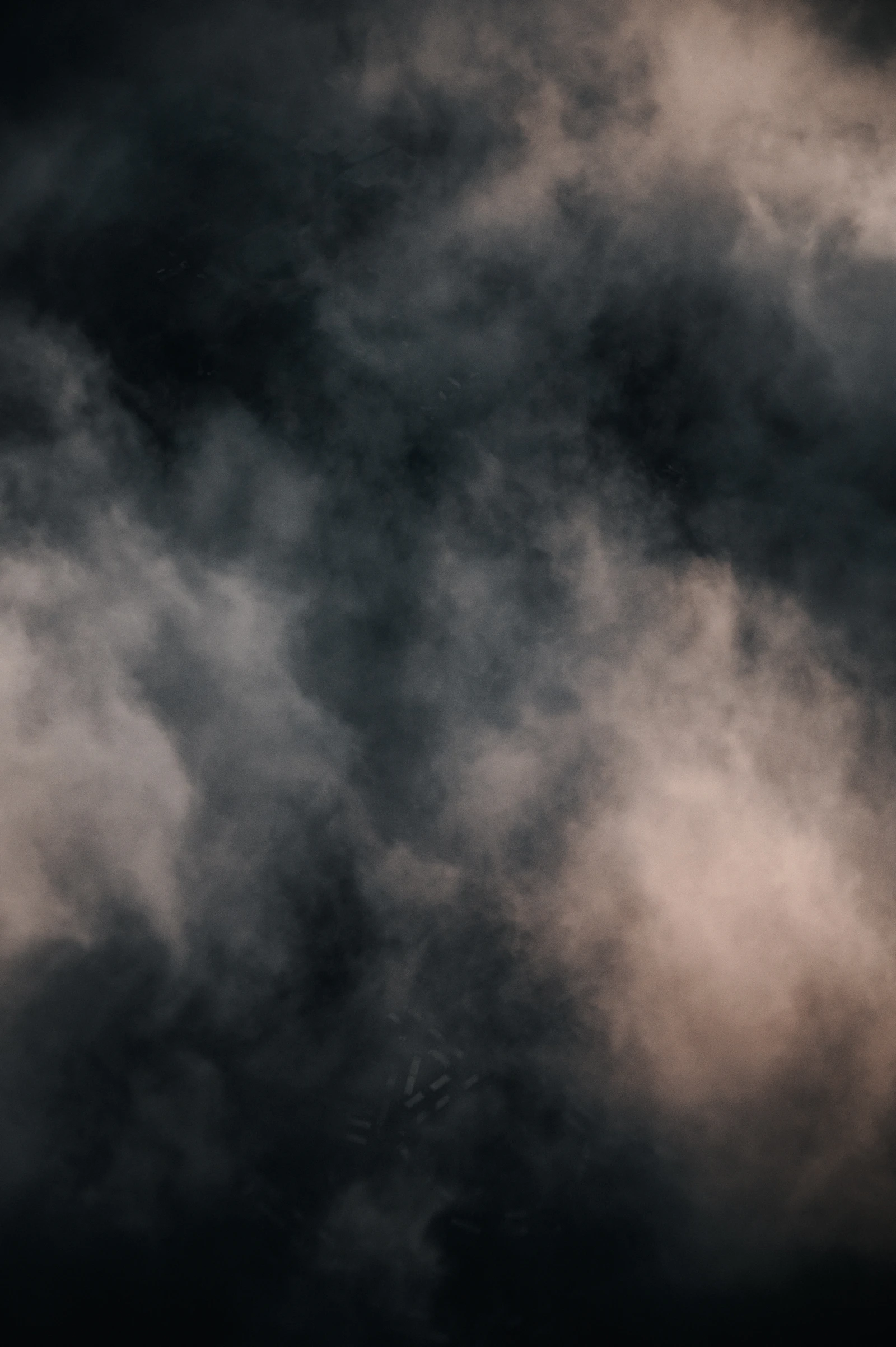 A sky filled with thick brown and gray wildfire smoke