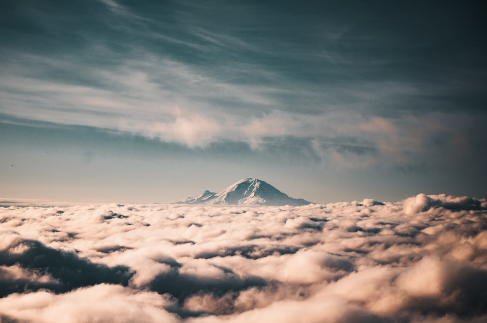 snow covered mountain under cloudy sky during daytime