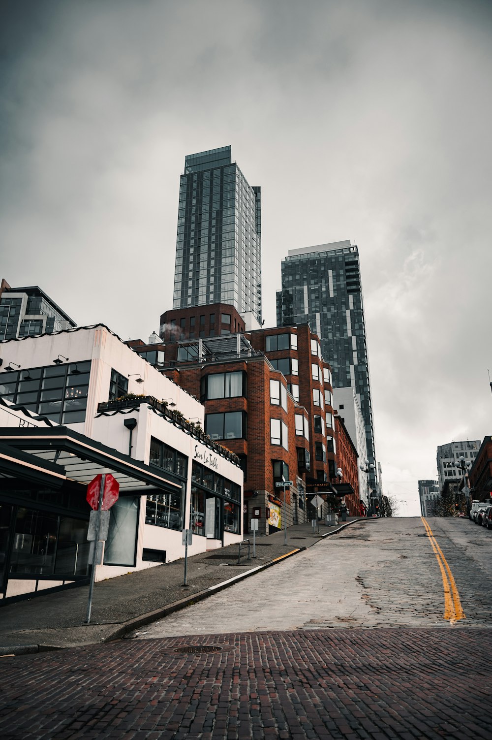 brown and white concrete building under white clouds during daytime