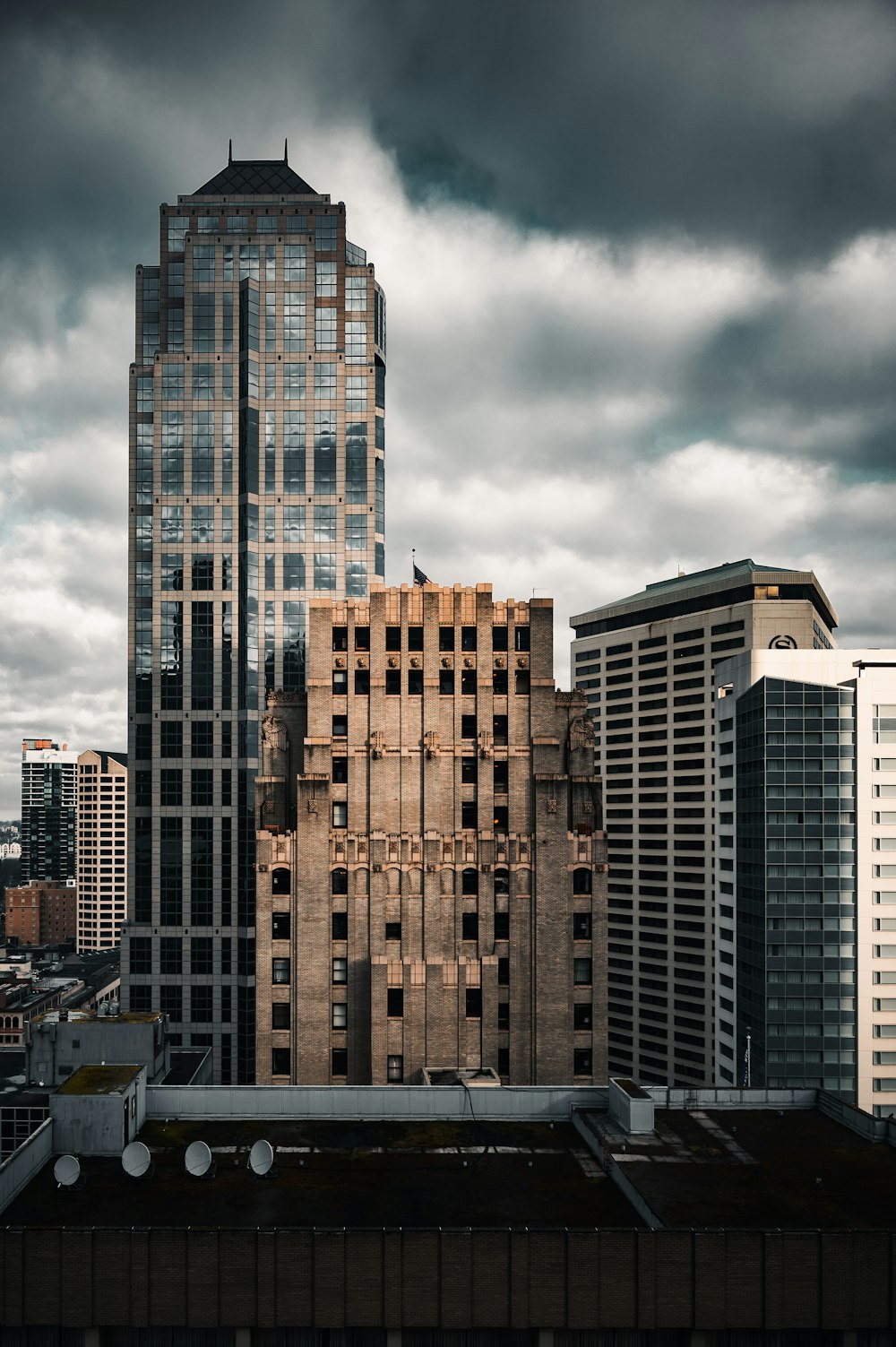 brown and black concrete building under gray clouds during daytime