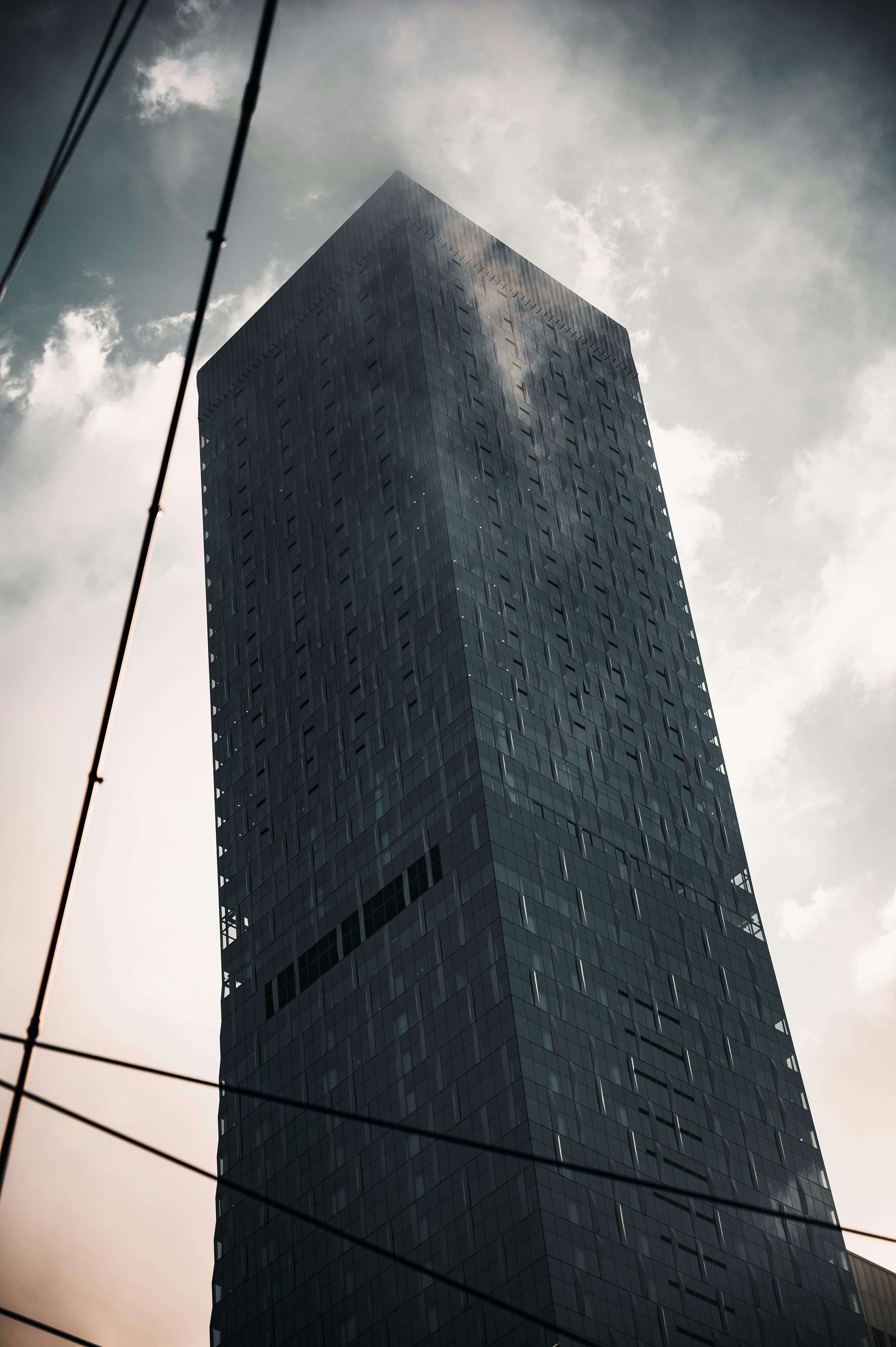 gray concrete building under white clouds during daytime