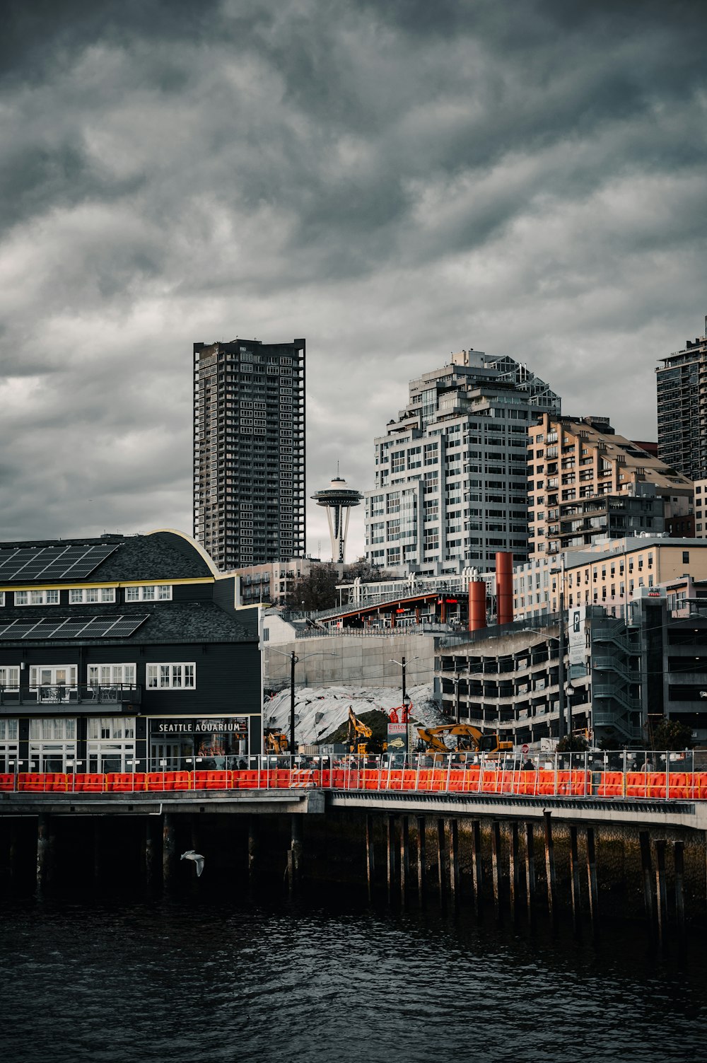 red and white ship on dock near city buildings during daytime