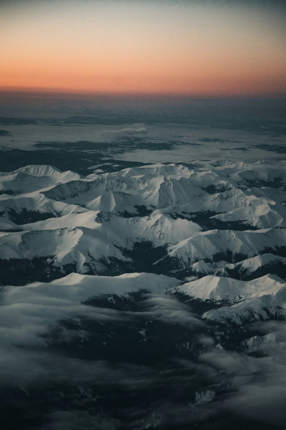 snow covered mountain during sunset
