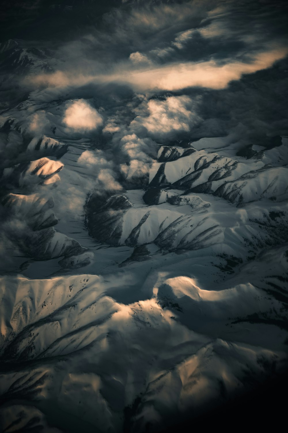 white clouds over snow covered mountains