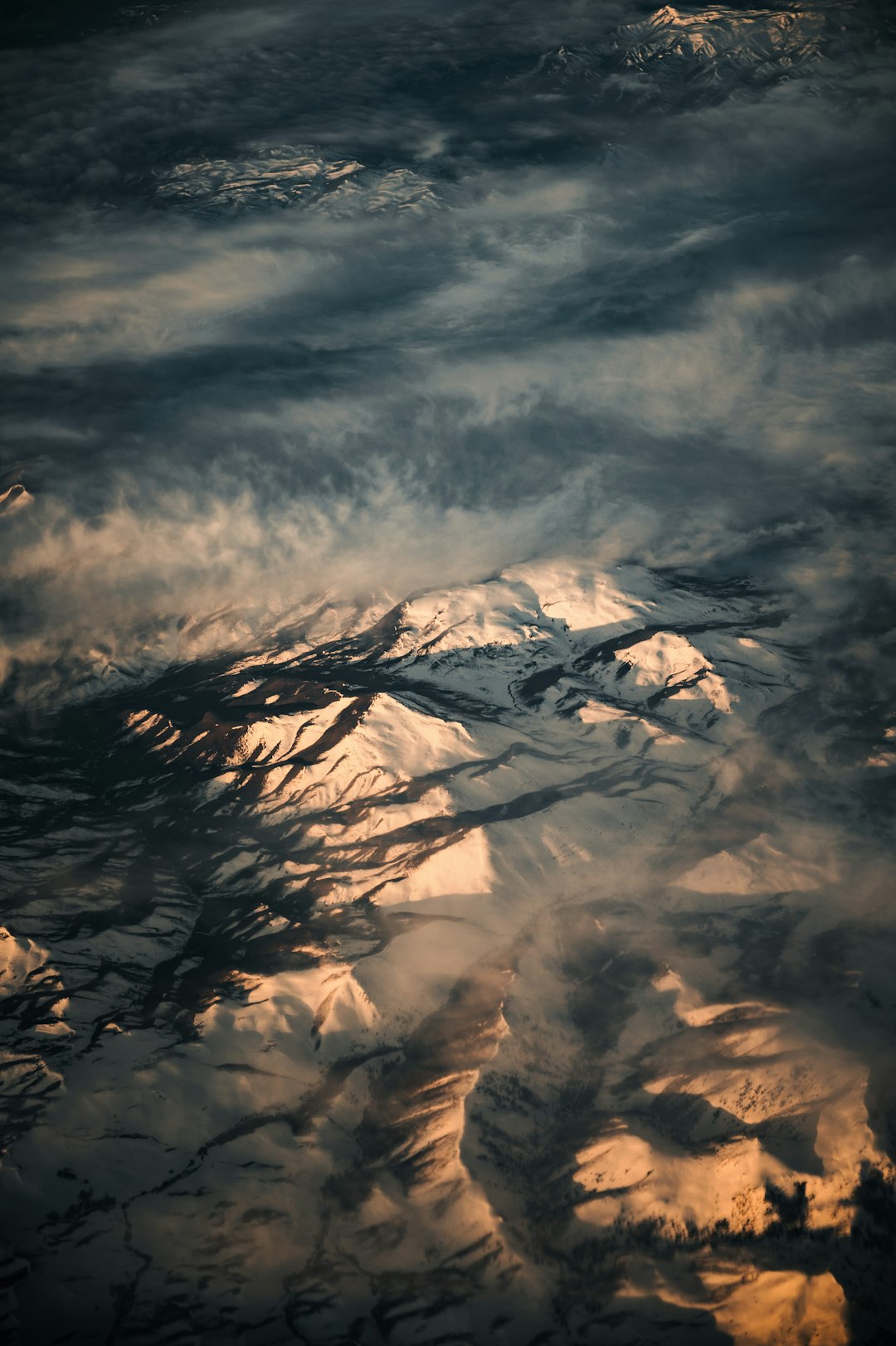 snow covered mountain under cloudy sky during daytime