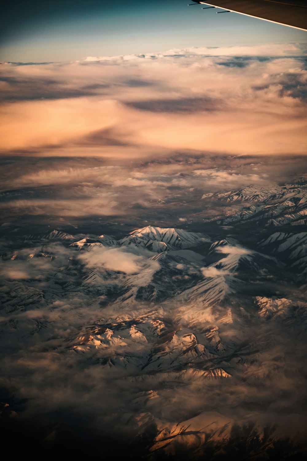 white clouds over snow covered mountains