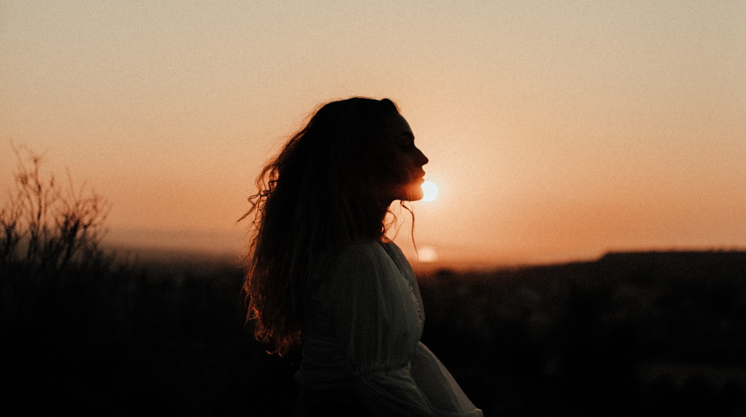 woman in white shirt standing during sunset