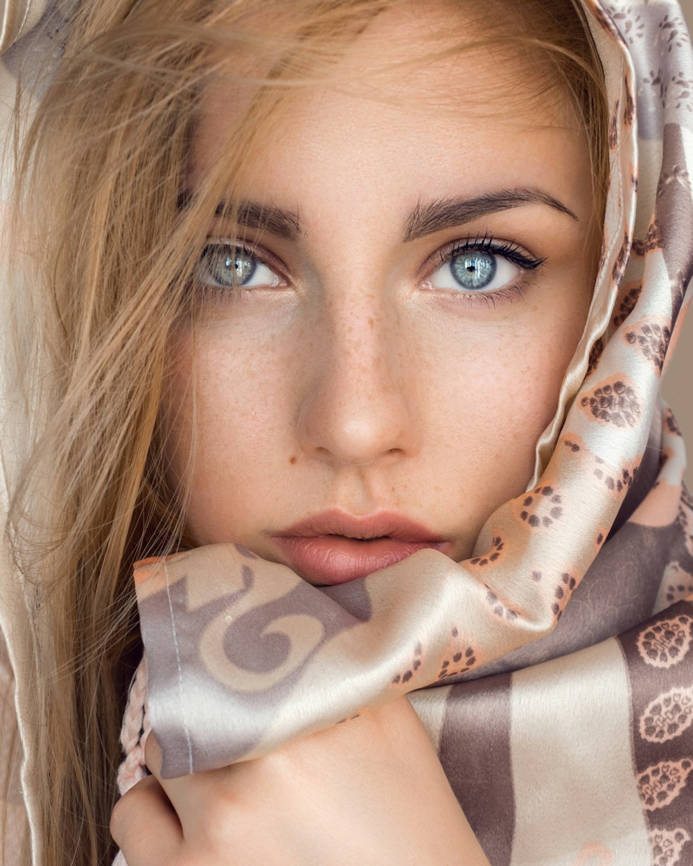 woman with brown and white floral scarf