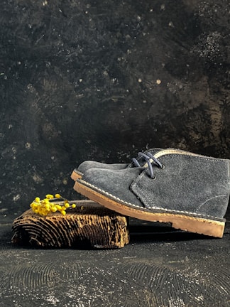 Worn suede shoe before treatment, with visible stains and discoloration.