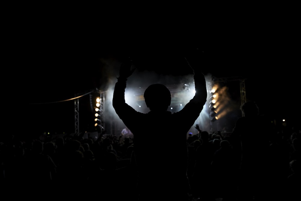 silhouette of man raising his hands