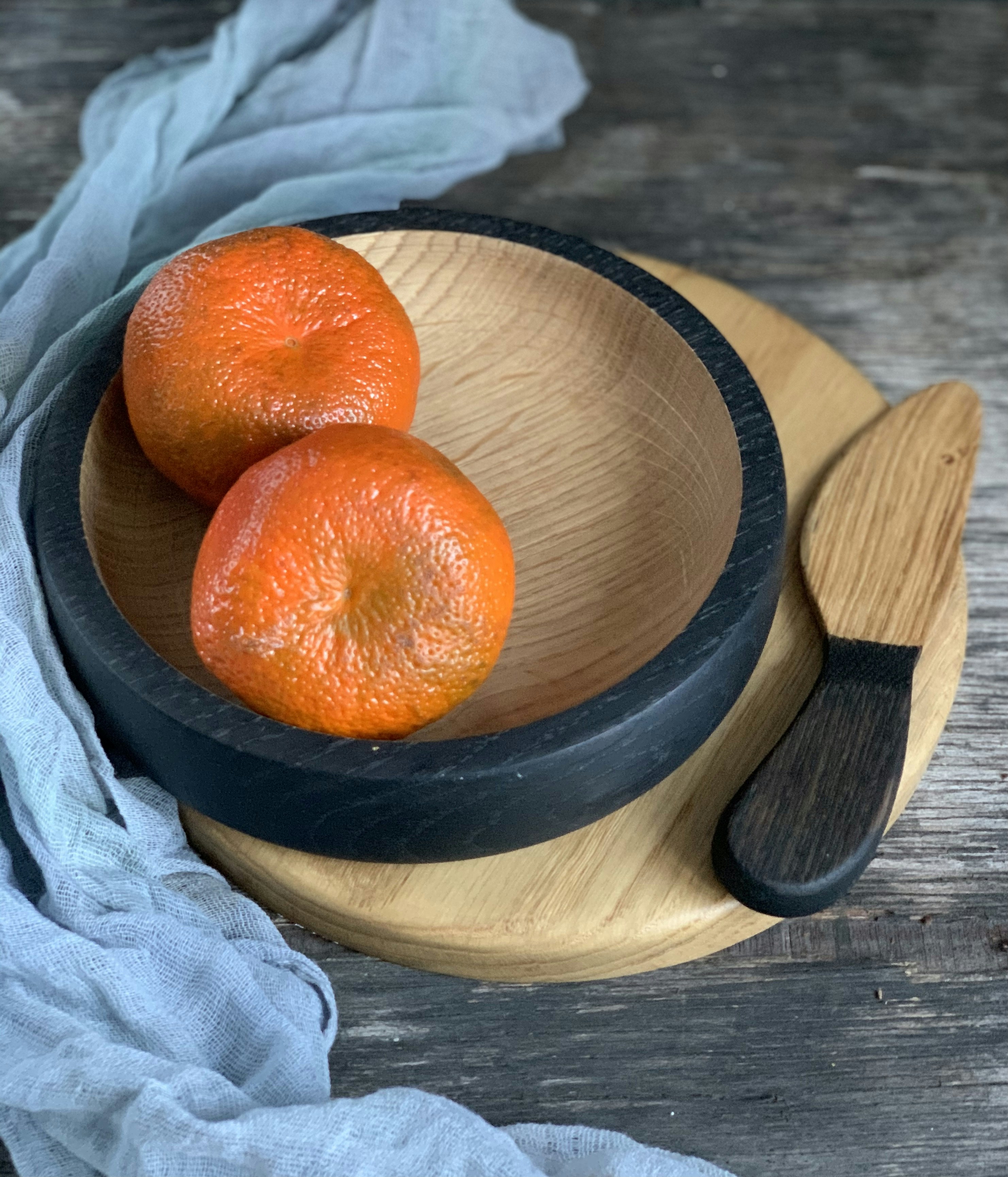 Bright small Japanese tangerines in a wooden bowl in warm morning light