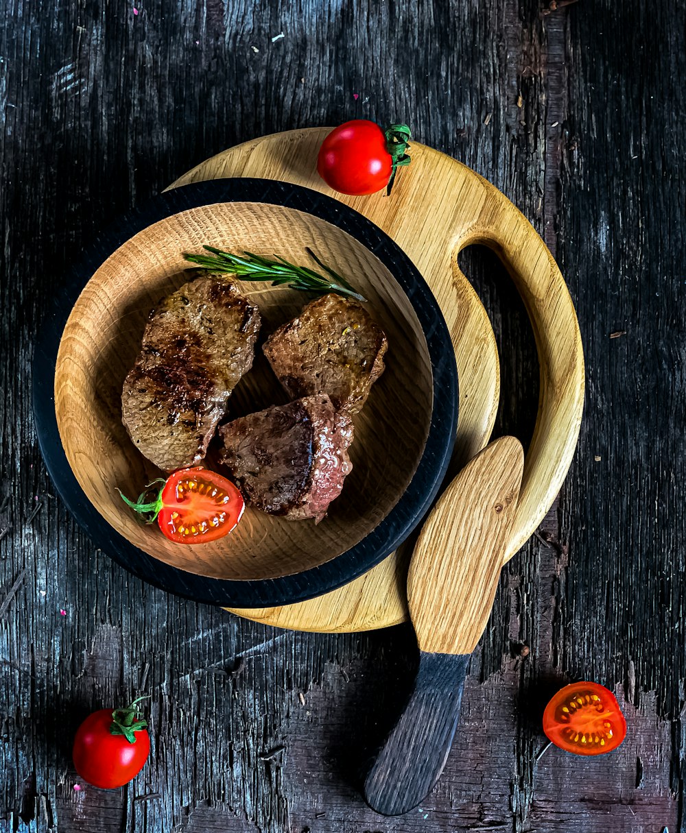 sliced meat on brown wooden round plate