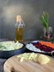A cozy kitchen scene featuring a wooden cutting board with fresh vegetables and a stylish ceramic bowl.