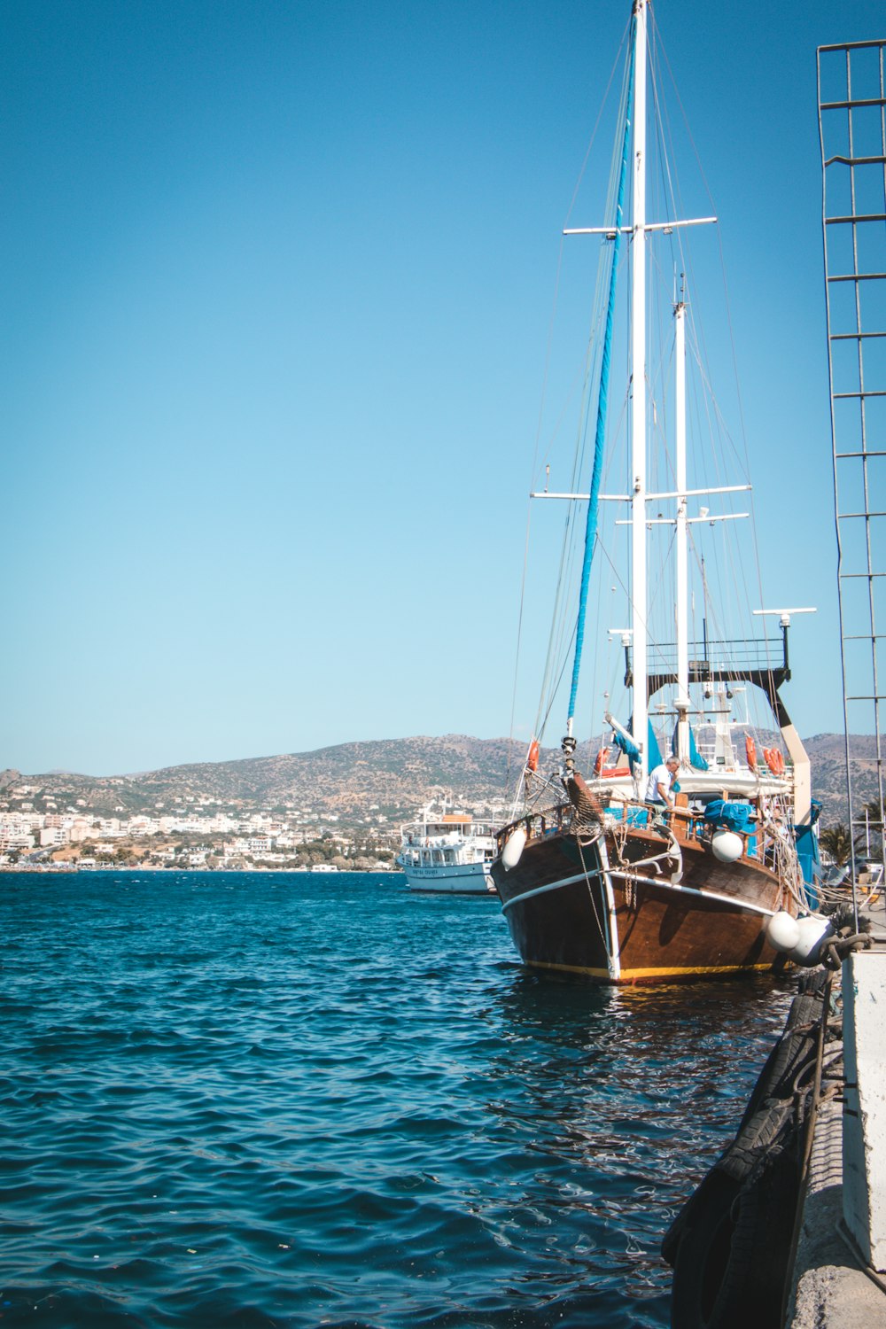 brown and white sail boat on sea during daytime