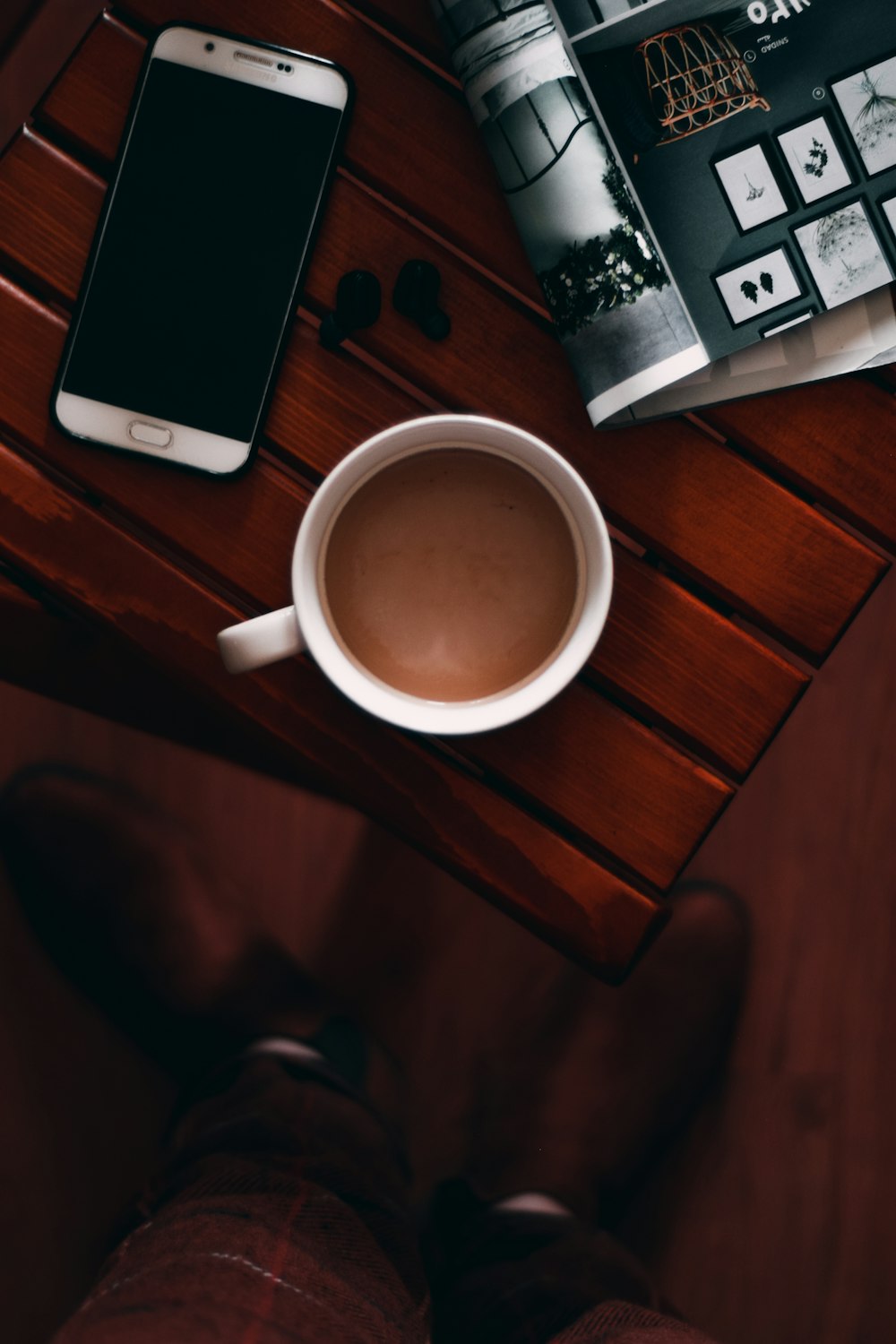 white ceramic mug on brown wooden table