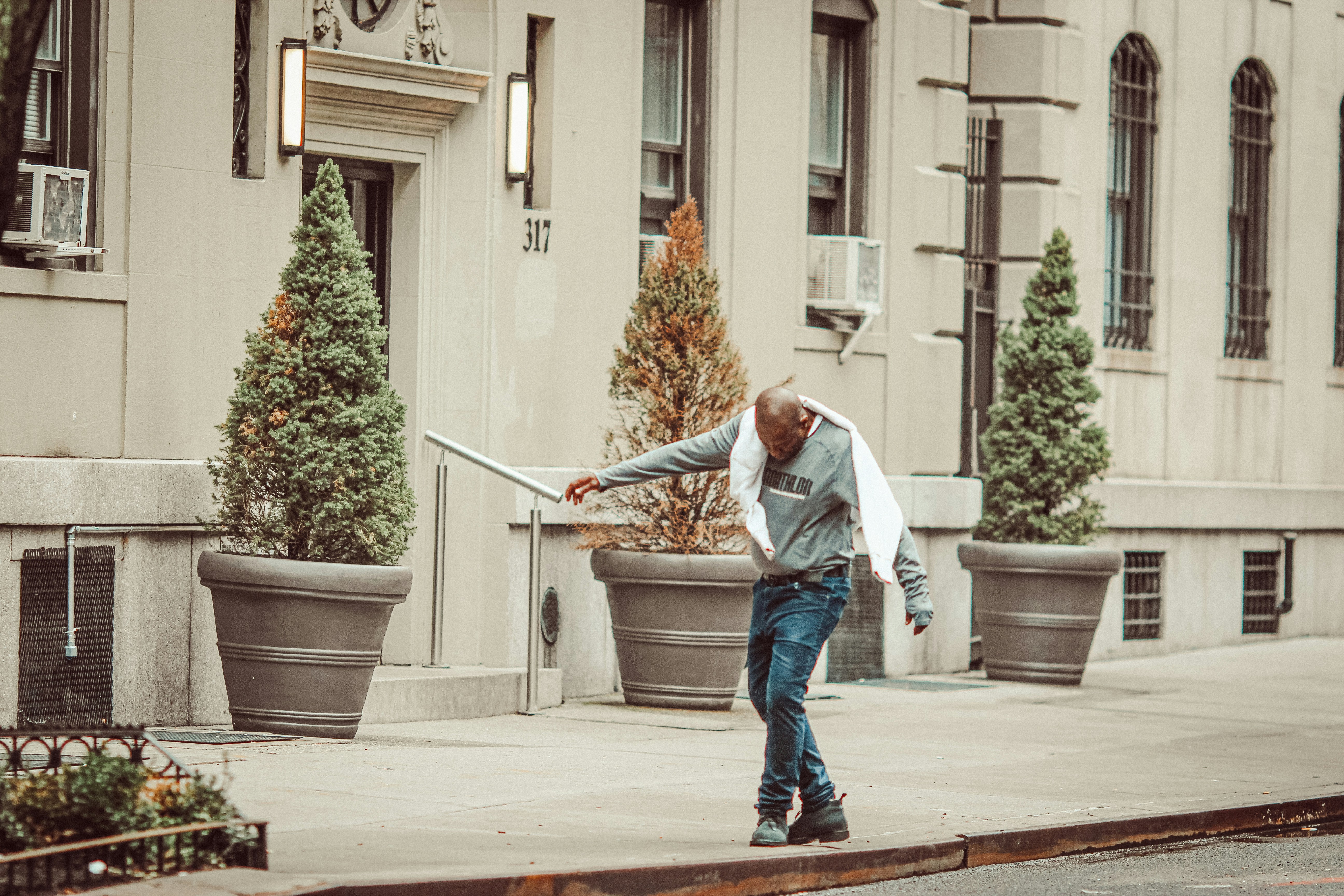 person using a broomstick for mobility drills - Home combat training