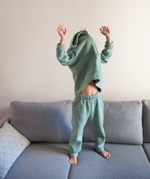 a person jumping on a couch in a living room