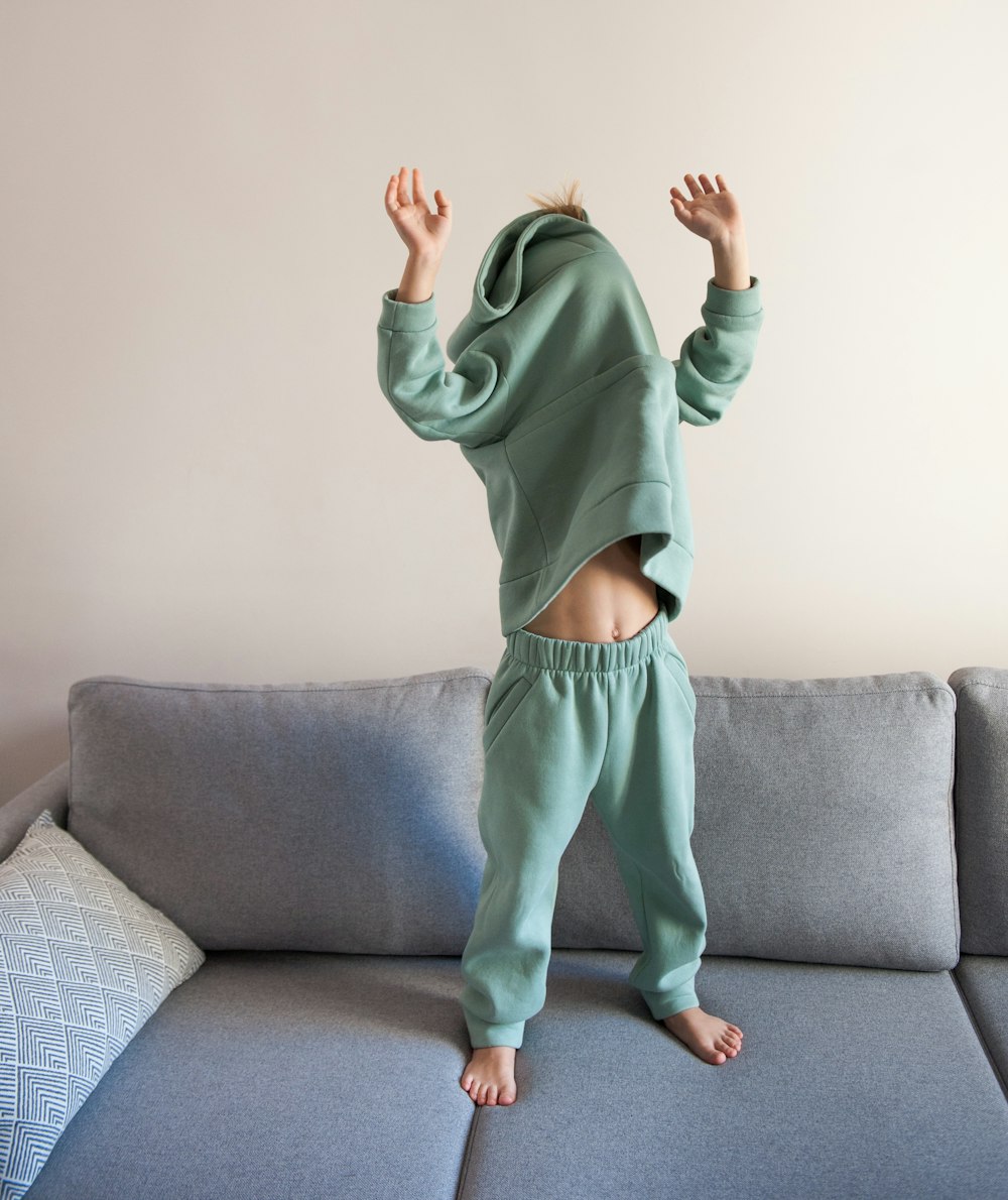 a person jumping on a couch in a living room