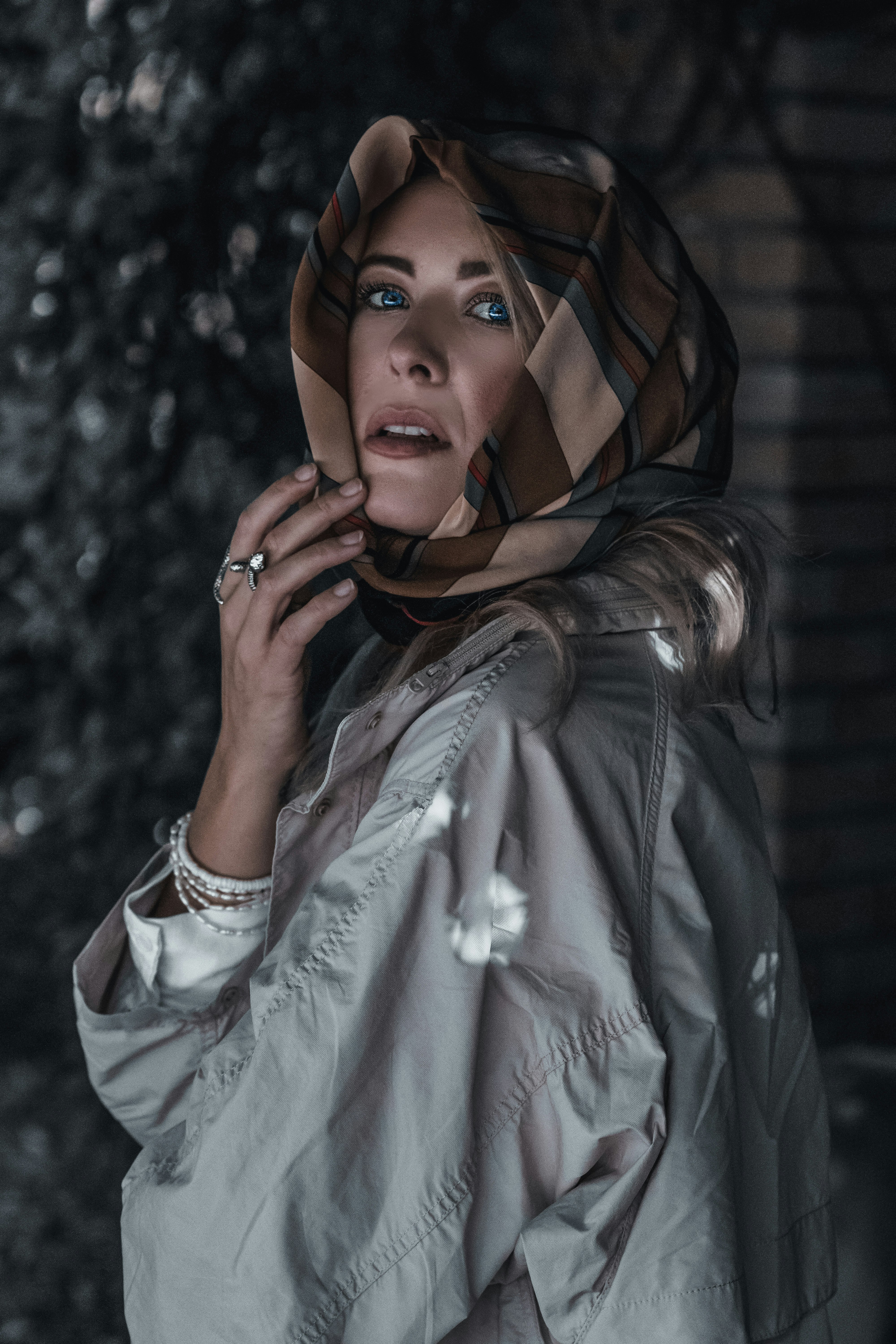 woman in white long sleeve shirt covering her face with her hands