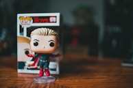 A customer happily holding a newly purchased Funko Pop in the gecoteno store.