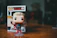 Close-up of a rare One Piece Funko Pop figure displayed on a sleek black shelf.