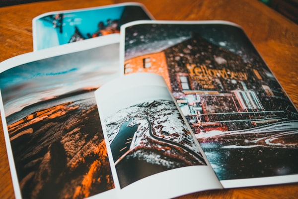 Print studio workspace with archival paper stacks, ink cartridges, and a large format printer