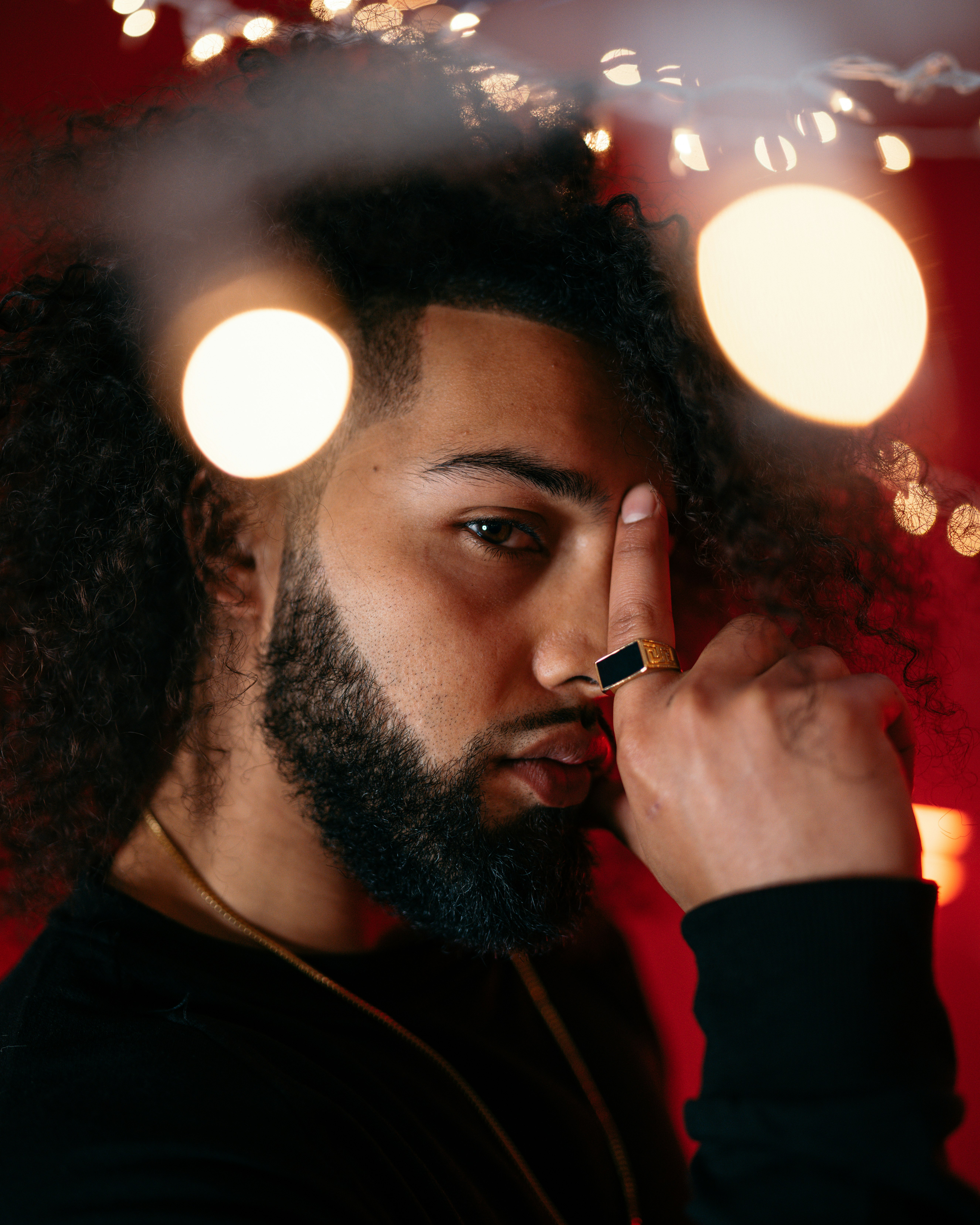 man in black crew neck shirt smoking cigarette