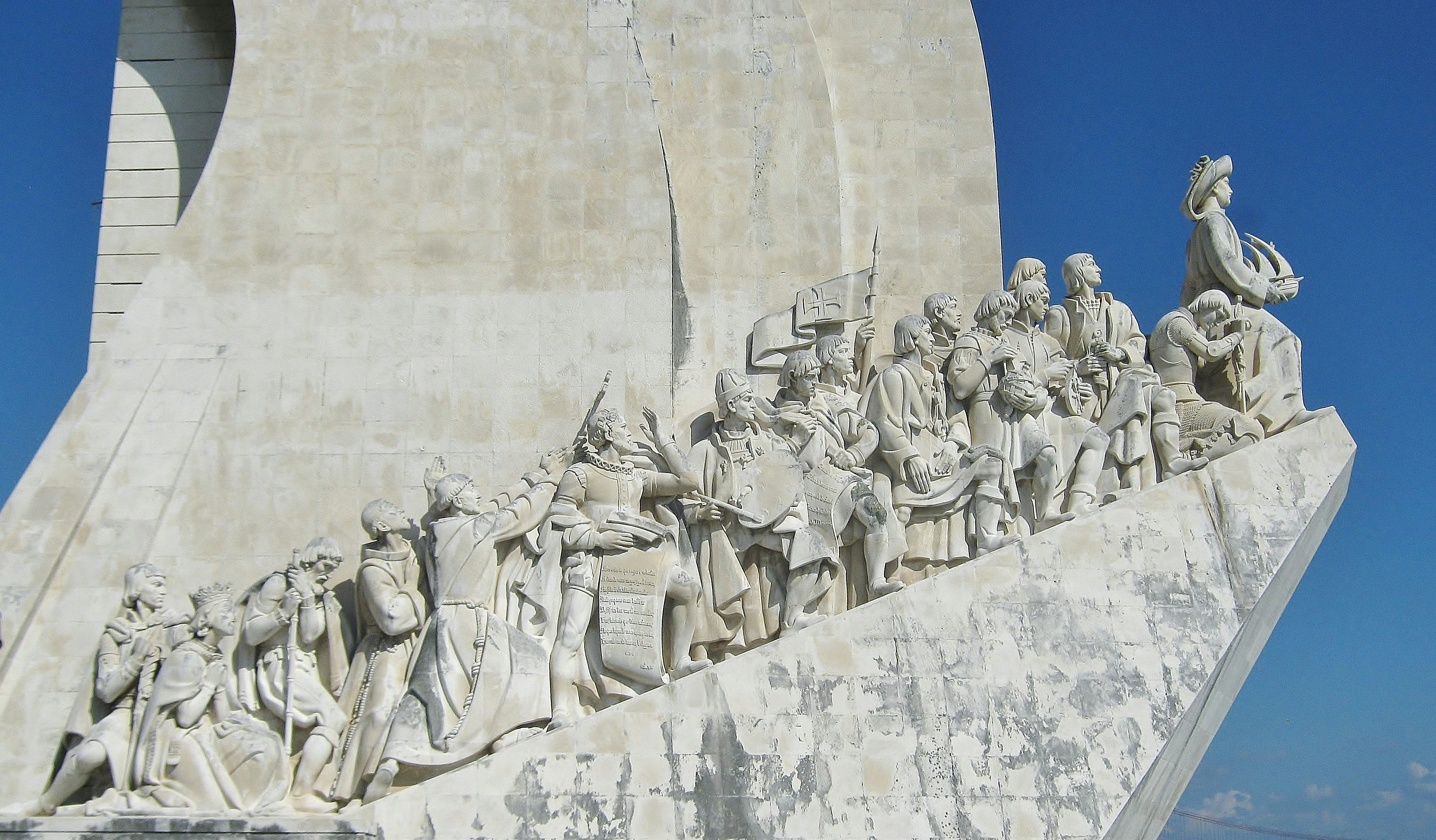 gray concrete statues on white concrete wall