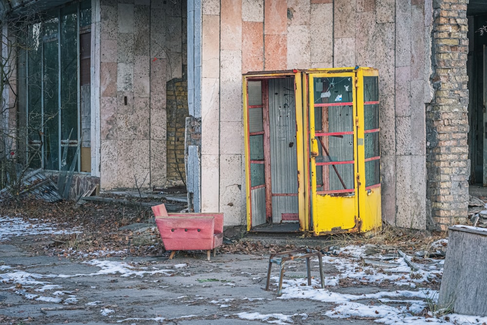 red plastic crate beside yellow door