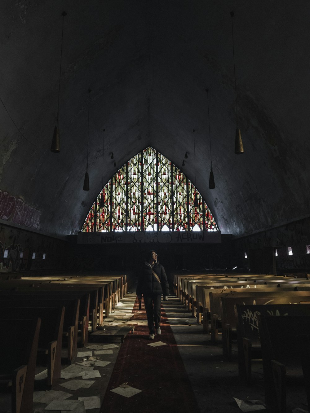 two people standing in front of a stained glass window