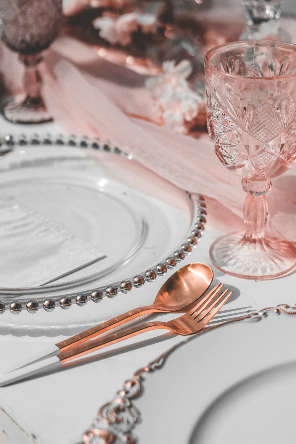 silver spoon beside clear cut glass bowl