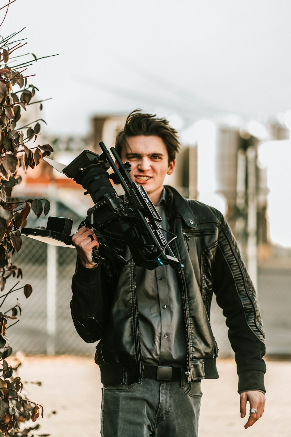 woman in black leather jacket holding black camera